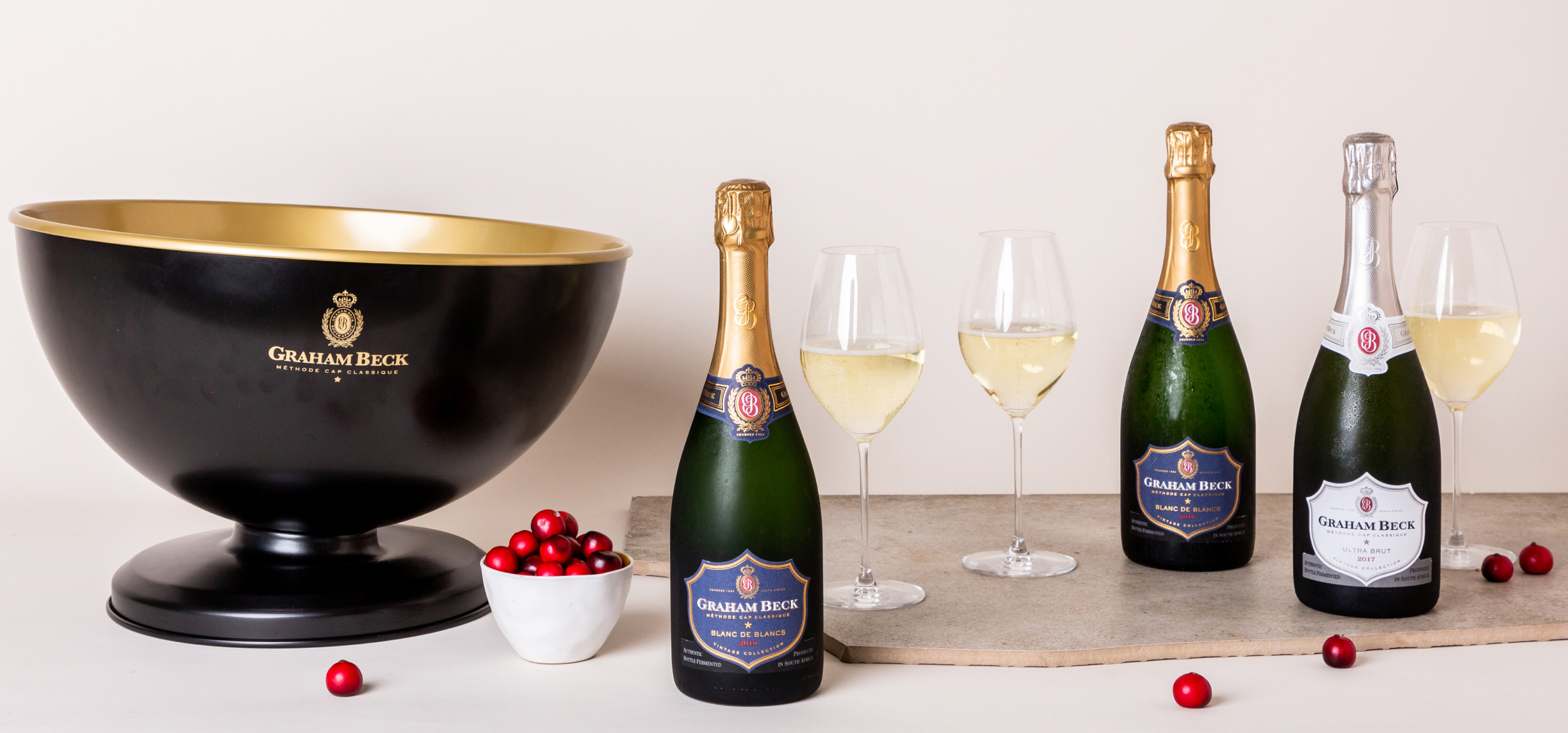 GRAHAM BECK  Graham Beck Leather Apron, Black & Gold Bistro Bucket, Bubbly Stopper,   6 x Riedel Veritas Glasses, 2 bottles of Graham Beck Blanc de Blancs 2018,   2 bottles of Graham Beck Pinot Noir Rosé 2017,   and 2 bottles of Graham Beck Ultra Brut 2017