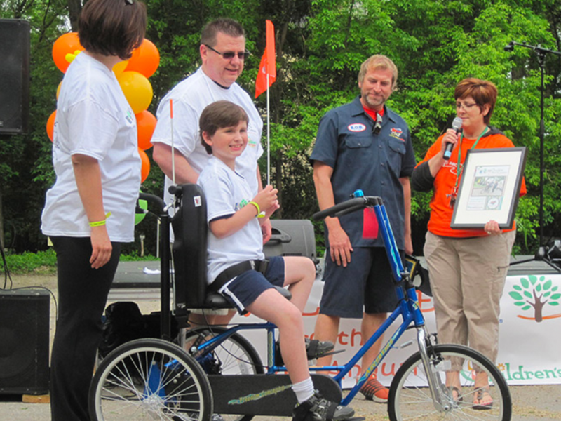 A child with special needs on an adaptive bike from Freedom Concepts