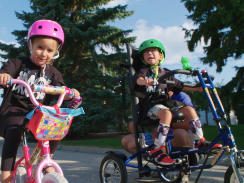Two children with special needs on adaptive bikes from Freedom Concepts