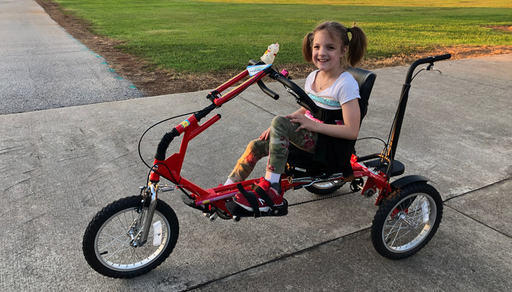 Tallie’s Lyon riding an adaptive bike from The Dream Bike Sponsorship Program