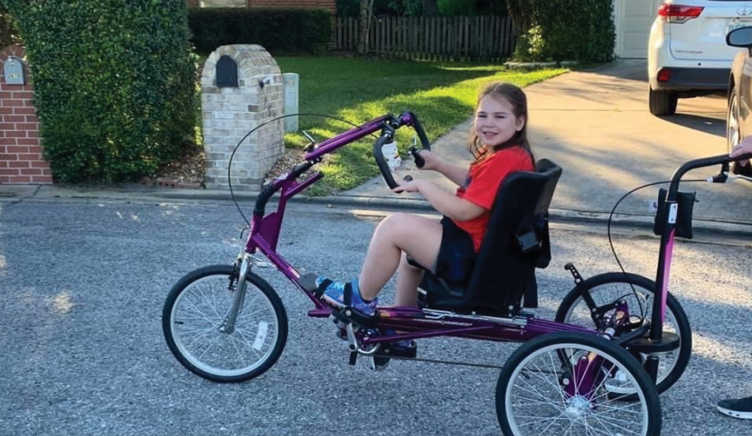Hannah Killebrew riding an adaptive bike from The Dream Bike Sponsorship Program