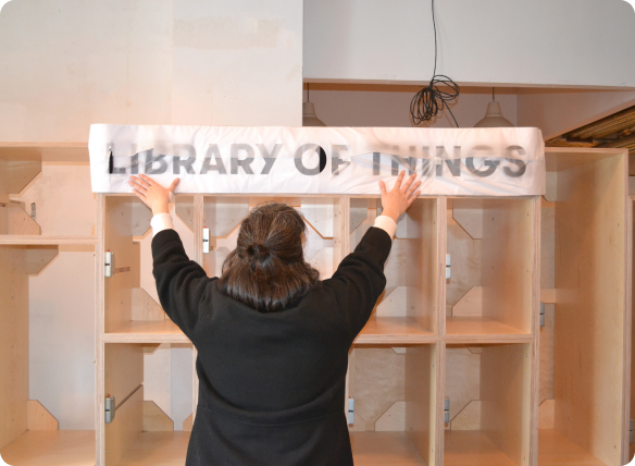 Image of someone installing a library of things kiosk