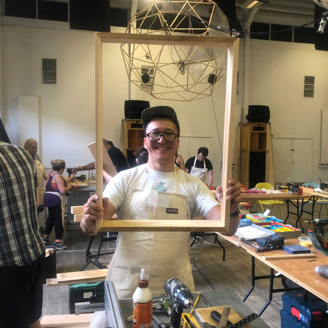 Image of a person with a picture frame they built