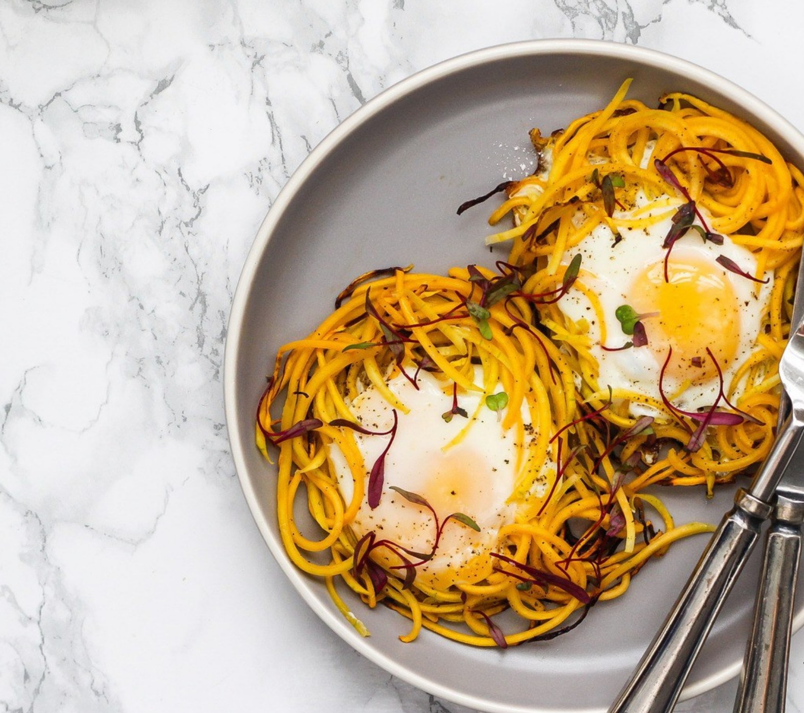 Baked eggs nestled in spiralized butternut squash—an anti-inflammatory, protein-rich breakfast option.